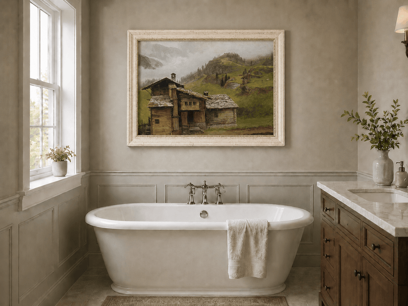 Framed hand-painted alpine landscape oil painting with a chalet, pasture and bell tower displayed above a freestanding bathtub.