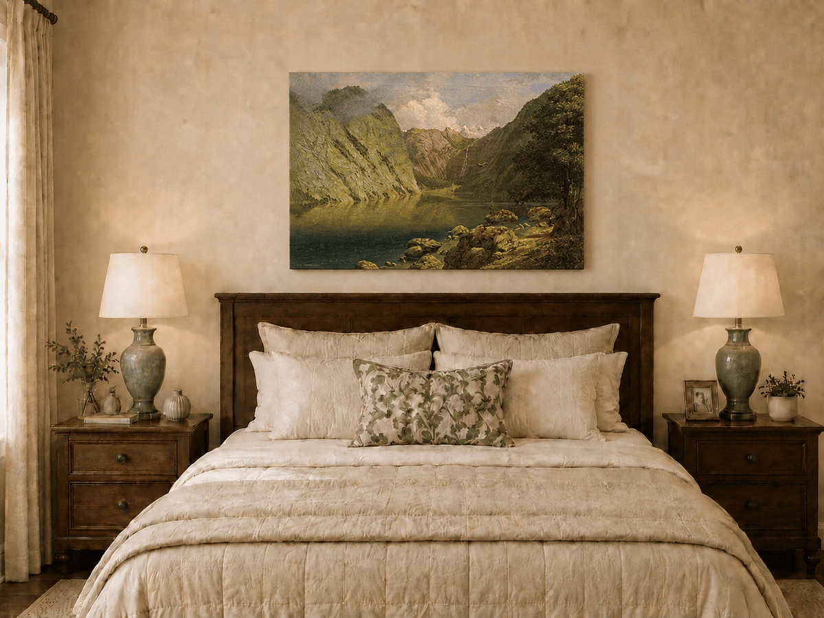 Unframed hand-painted alpine lake valley oil painting with a waterfall and rugged mountains displayed above a wooden bed in a neutral bedroom.