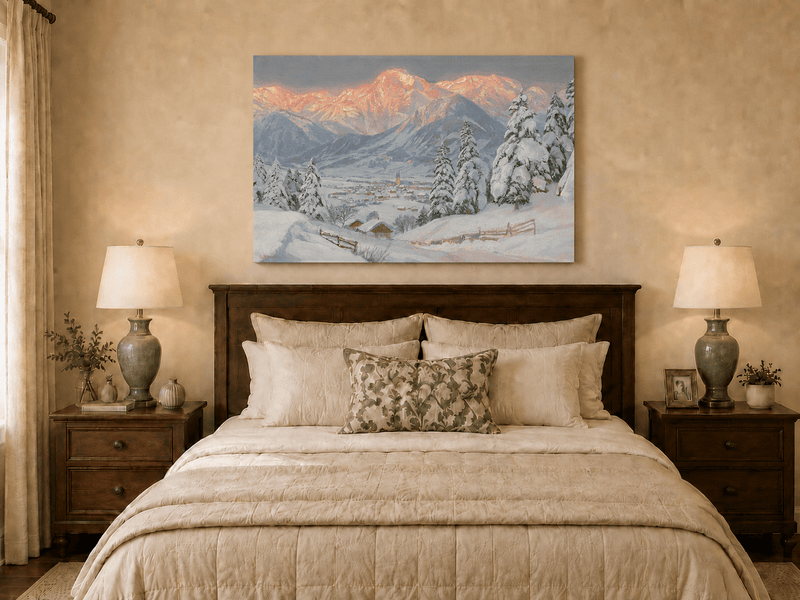 Unframed hand-painted alpine town oil painting beneath glowing pink mountain peaks displayed above a wooden bed in a neutral bedroom.