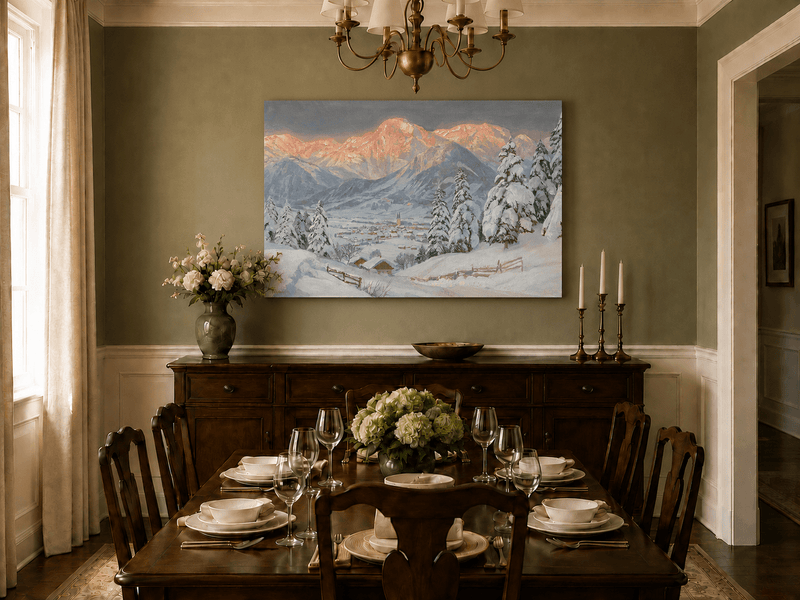 Unframed hand-painted alpine town oil painting beneath glowing pink mountain peaks displayed above a formal dining table.