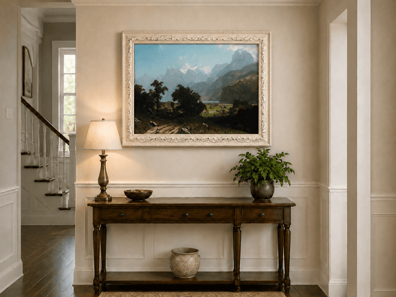 Framed hand-painted alpine valley oil painting with a lake and layered mountain peaks displayed above an entryway console table.