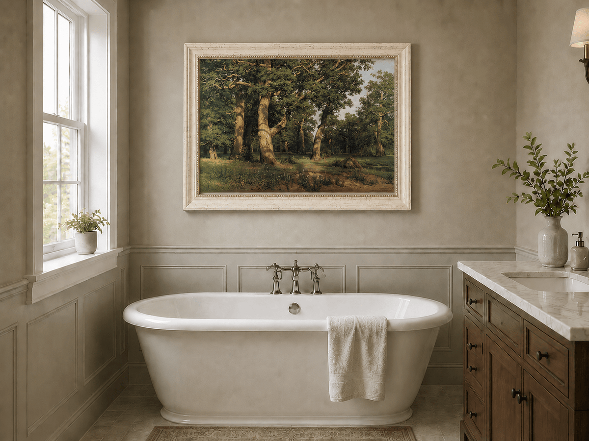 Framed hand-painted forest glade oil painting with ancient oak trees displayed above a freestanding bathtub.