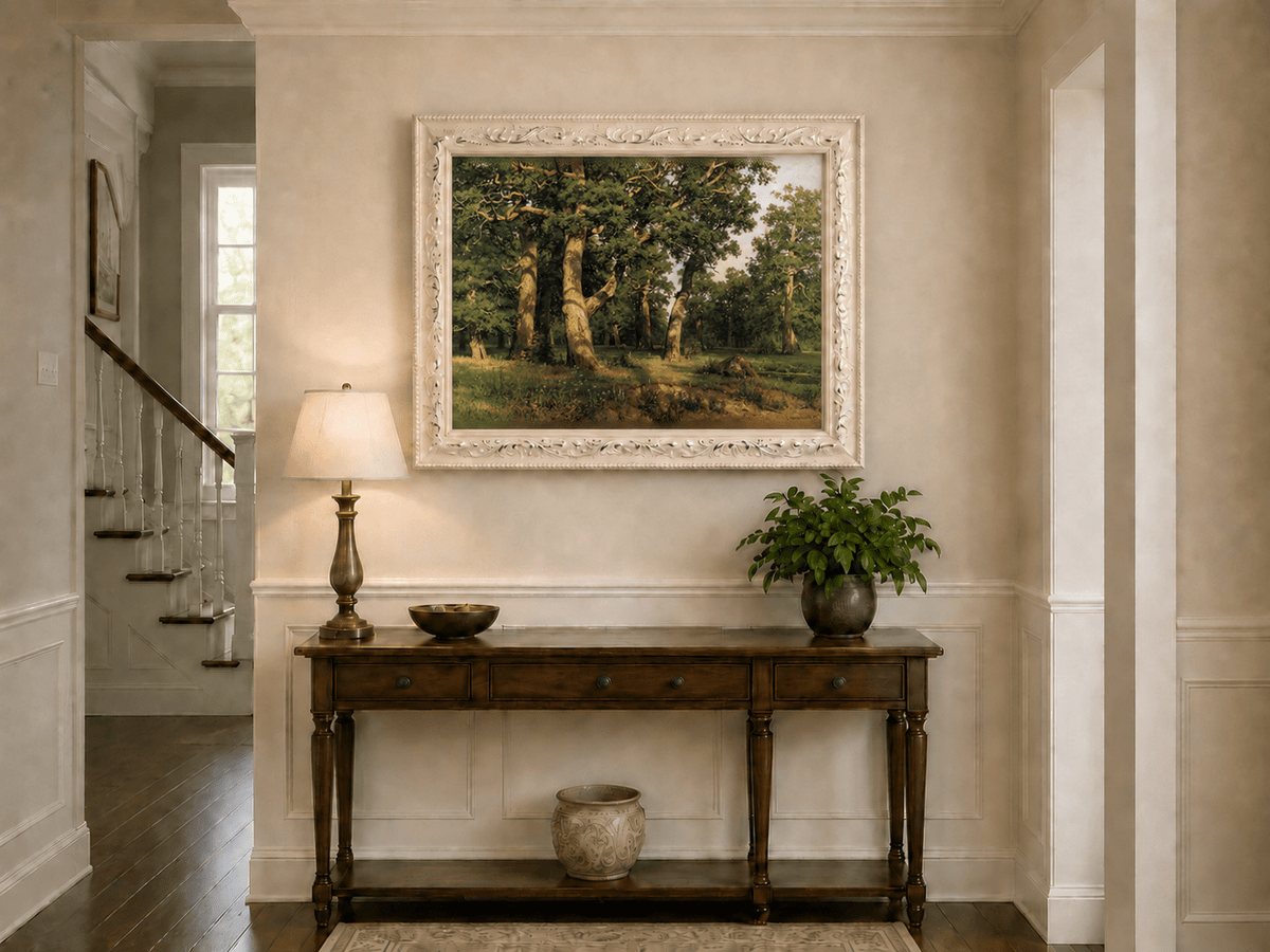 Framed hand-painted forest glade oil painting with ancient oak trees displayed above an entryway console table.