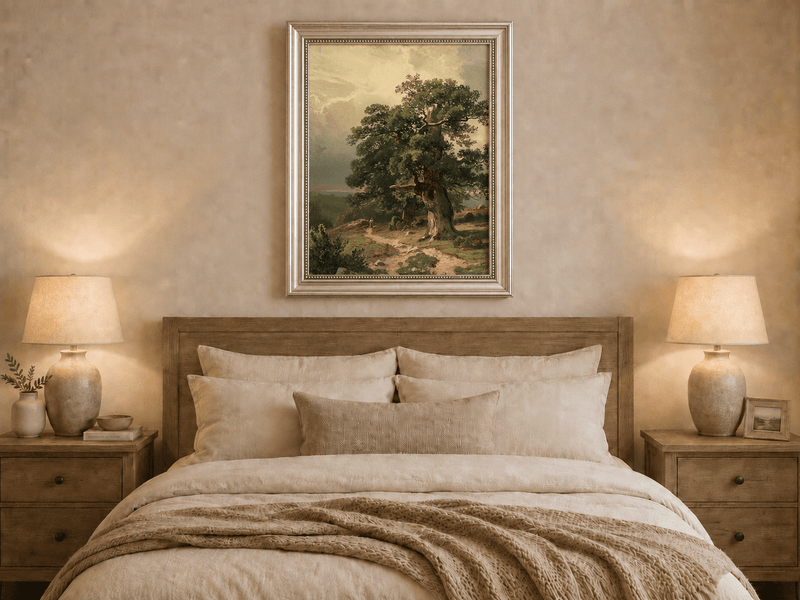 Framed hand-painted landscape oil painting with an ancient oak tree and winding path displayed above a wooden bed in a neutral bedroom.