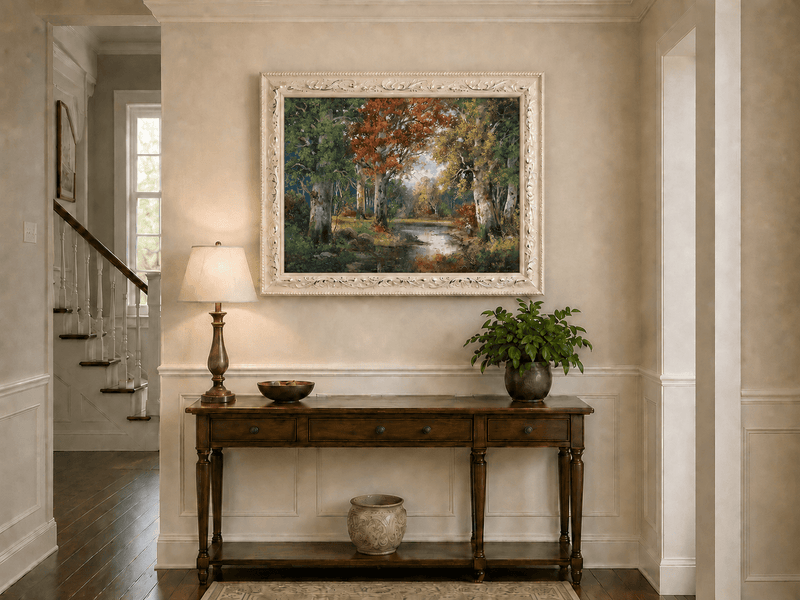 Framed hand-painted autumn forest lake oil painting with colorful trees and reflections displayed above an entryway console table.