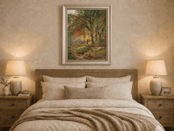 Framed hand-painted autumn forest oil painting with a leaf-covered path beside a stream displayed above a wooden bed in a neutral bedroom.