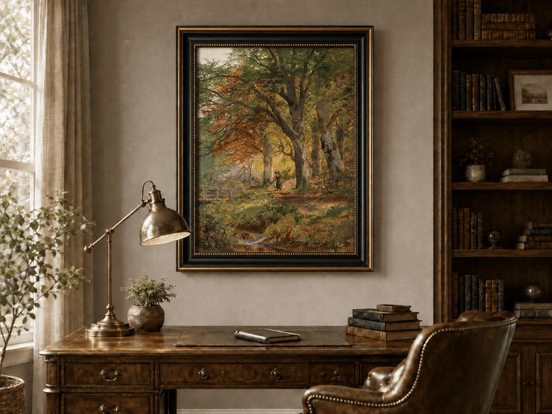 Framed hand-painted autumn forest oil painting with a leaf-covered path beside a stream displayed above a traditional home office desk.
