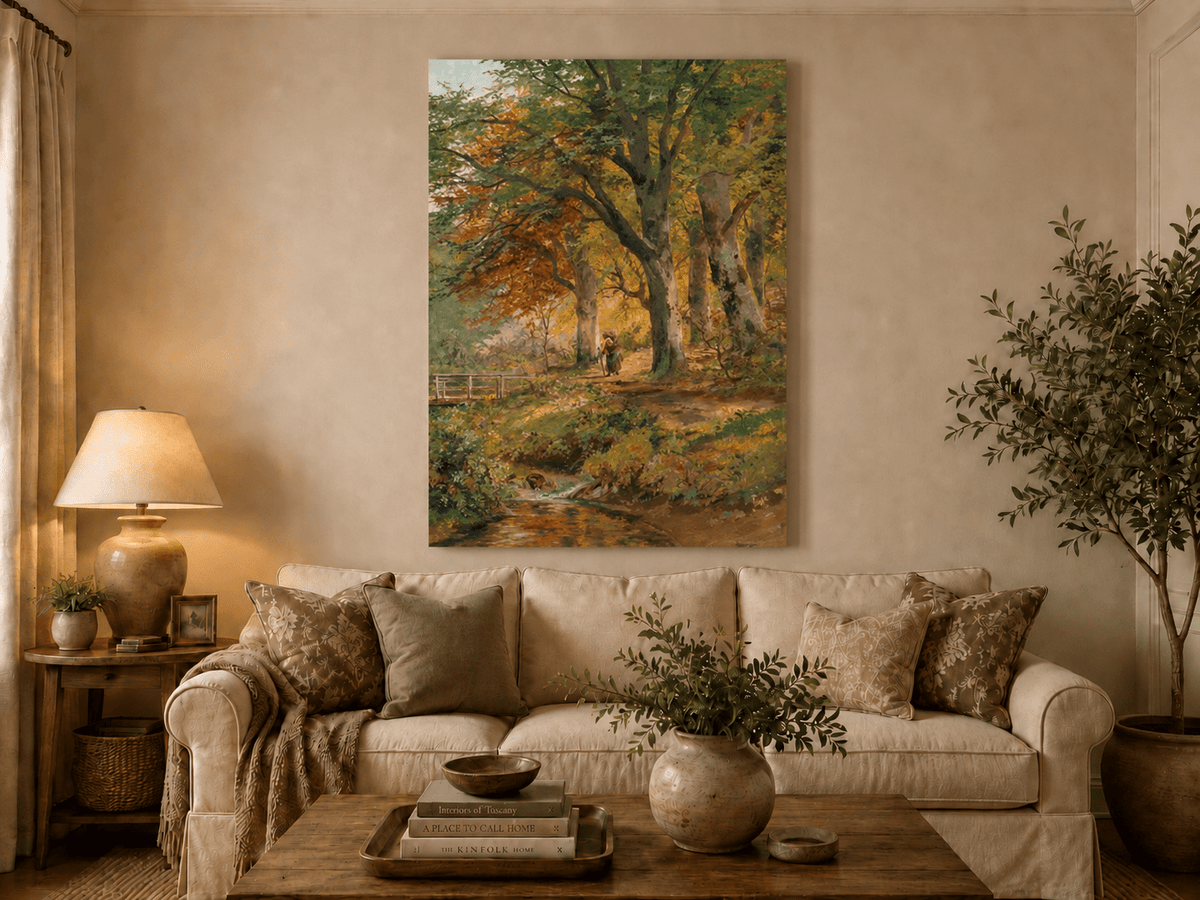 Unframed hand-painted autumn forest oil painting with a leaf-covered path beside a stream displayed above a neutral living room sofa.