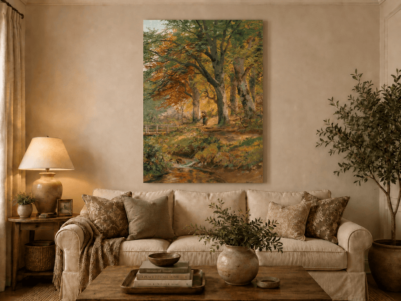 Unframed hand-painted autumn forest oil painting with a leaf-covered path beside a stream displayed above a neutral living room sofa.