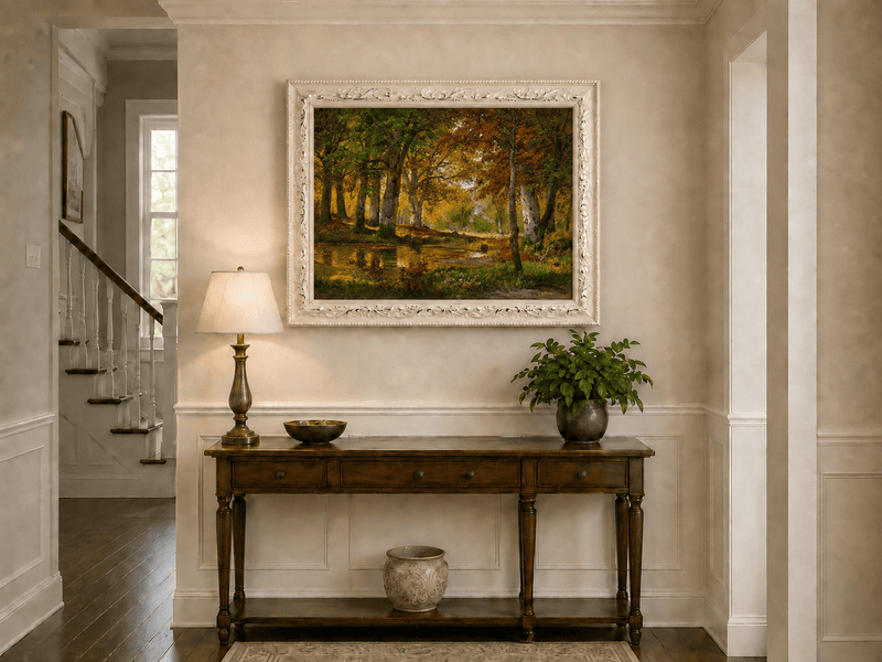 Framed hand-painted autumn forest pond oil painting with golden trees reflected in still water displayed above an entryway console table.
