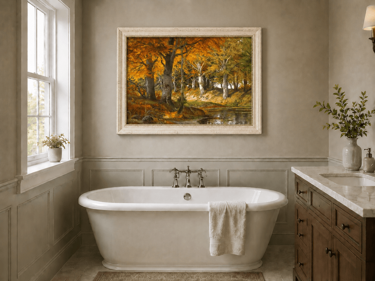 Framed hand-painted autumn forest stream oil painting glowing beneath golden trees displayed above a freestanding bathtub.