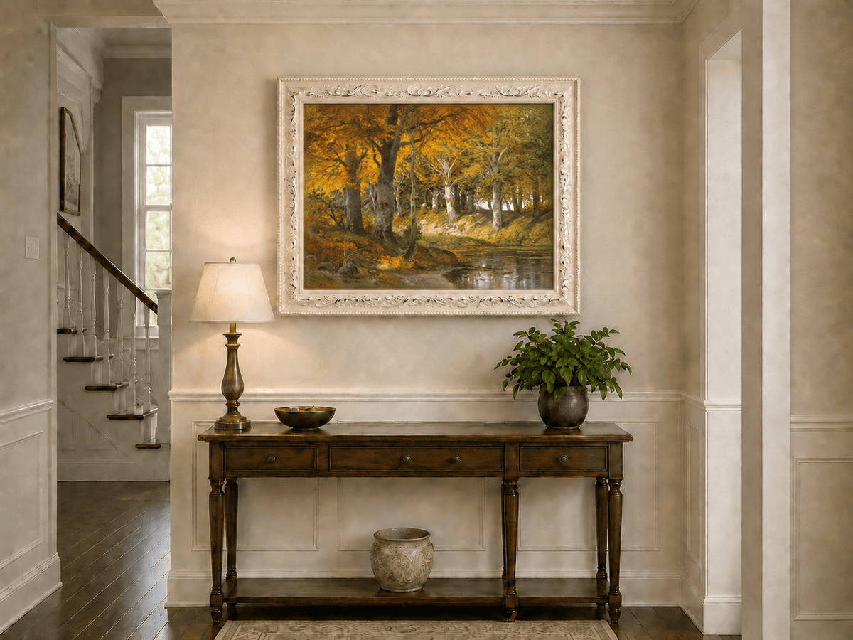 Framed hand-painted autumn forest stream oil painting glowing beneath golden trees displayed above an entryway console table.