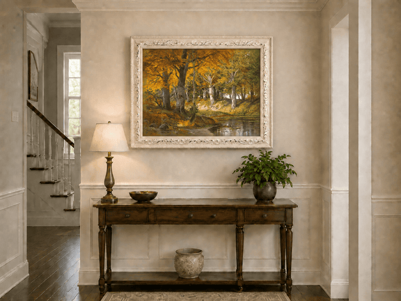 Framed hand-painted autumn forest stream oil painting glowing beneath golden trees displayed above an entryway console table.