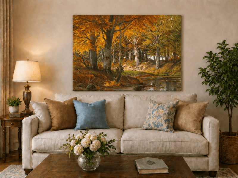 Unframed hand-painted autumn forest stream oil painting glowing beneath golden trees displayed above a neutral living room sofa.