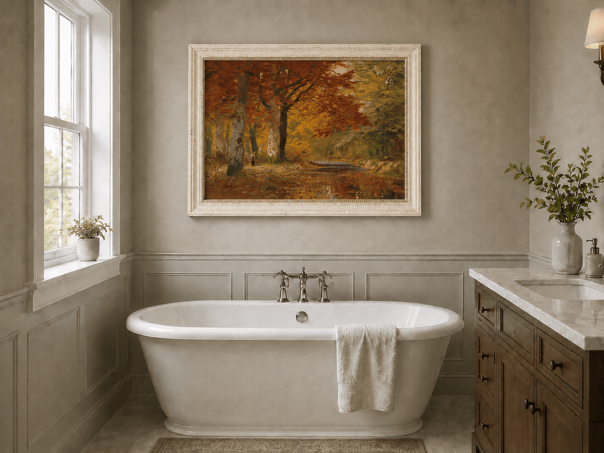 Framed hand-painted autumn forest oil painting with a stream and red-leaved trees displayed above a freestanding bathtub.