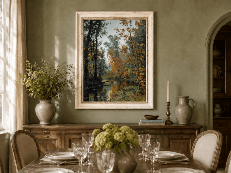 Framed hand-painted autumn forest stream oil painting with colorful trees and reflections displayed above a formal dining table.