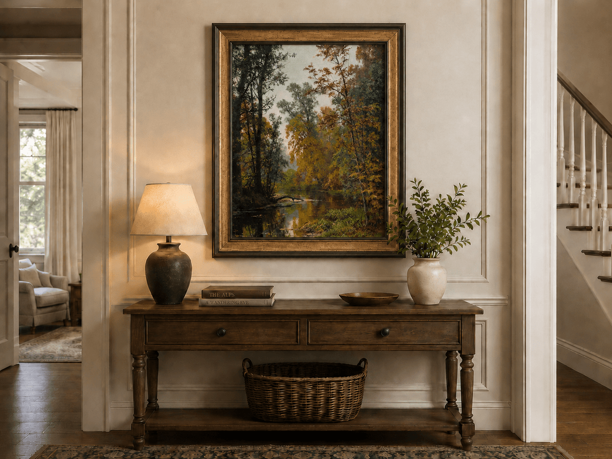 Framed hand-painted autumn forest stream oil painting with colorful trees and reflections displayed above an entryway console table.