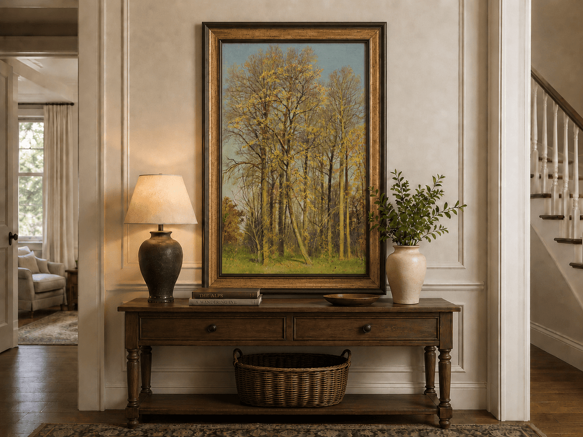 Framed hand-painted autumn forest oil painting with slender golden trees and bright foliage displayed above an entryway console table.