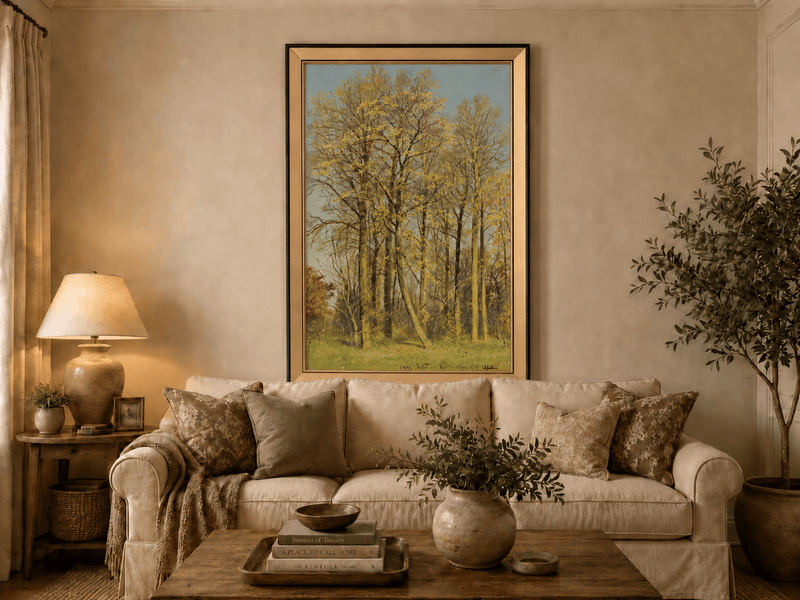 Framed hand-painted autumn forest oil painting with slender golden trees and bright foliage displayed above a neutral living room sofa.