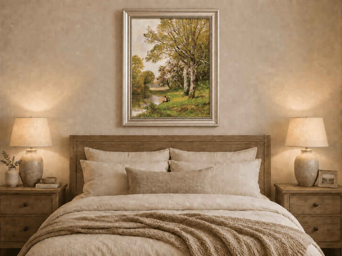 Framed hand-painted autumn riverside oil painting with a seated figure beneath birch trees displayed above a wooden bed in a neutral bedroom.