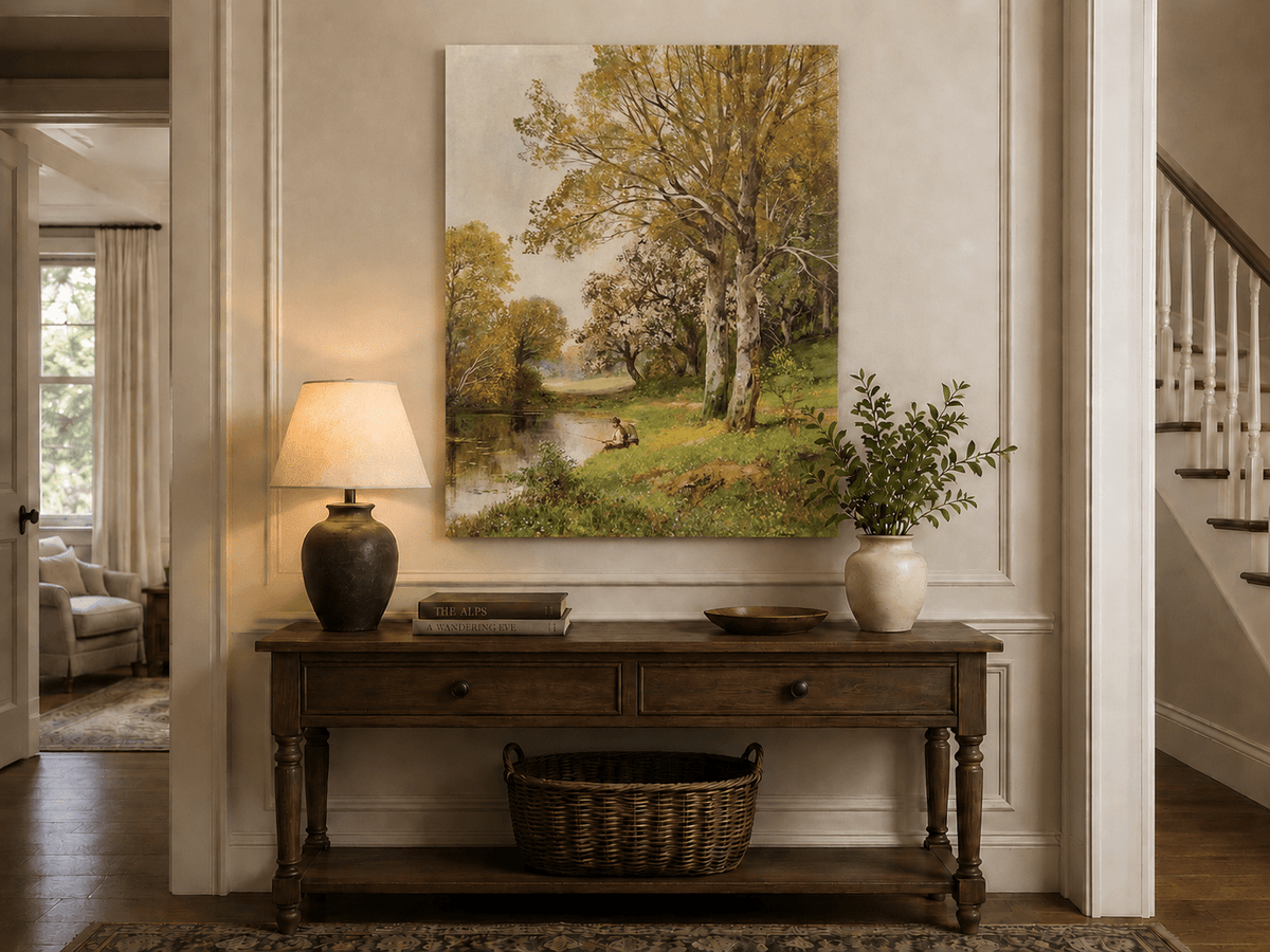 Unframed hand-painted autumn riverside oil painting with a seated figure beneath birch trees displayed above an entryway console table.