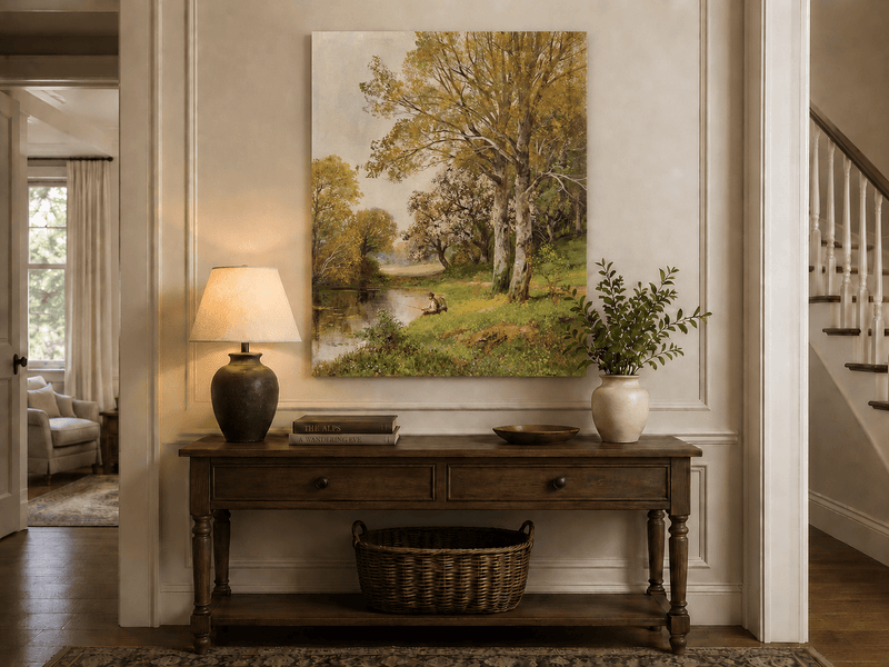 Unframed hand-painted autumn riverside oil painting with a seated figure beneath birch trees displayed above an entryway console table.