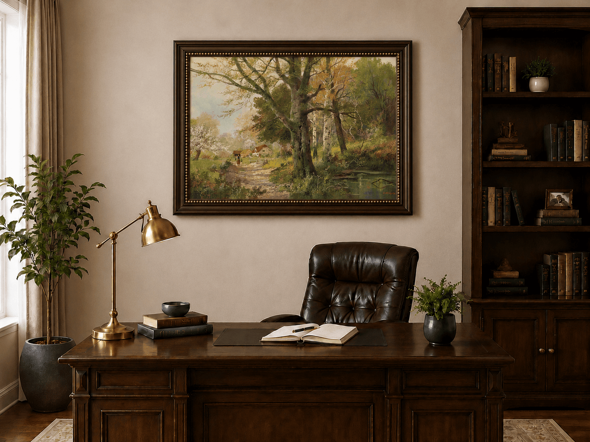 Framed hand-painted autumn woodland oil painting with a path leading to a country cottage displayed above a traditional home office desk.
