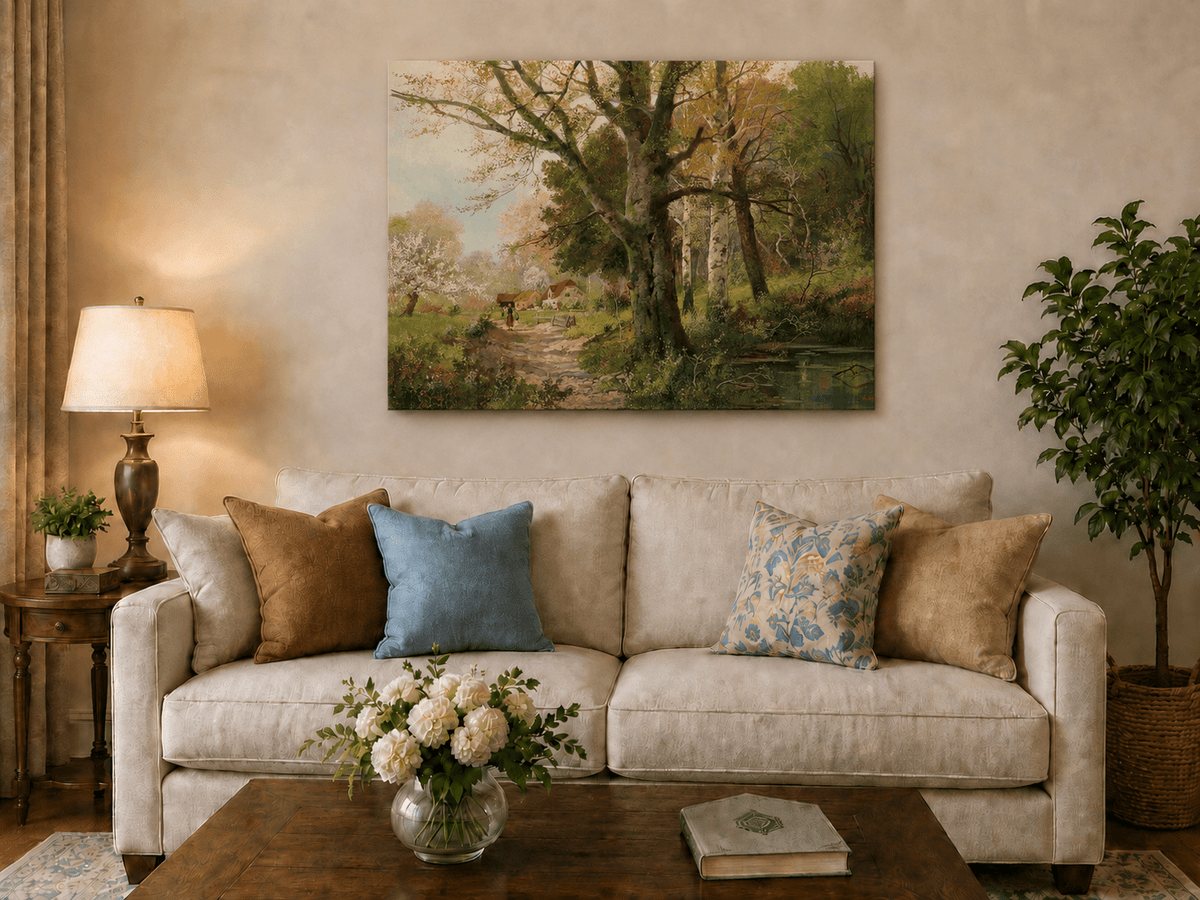 Unframed hand-painted autumn woodland oil painting with a path leading to a country cottage displayed above a neutral living room sofa.