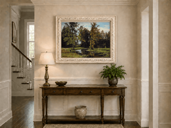 Framed hand-painted autumn woodland pond oil painting with trees reflected in still water displayed above an entryway console table.