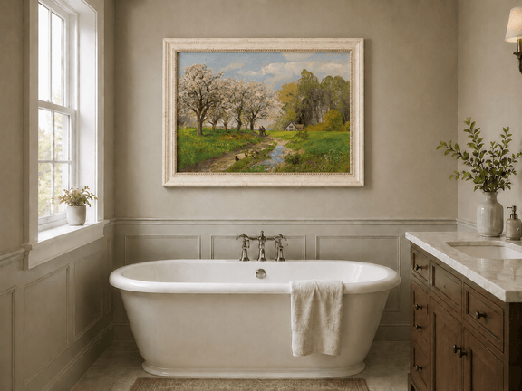 Framed hand-painted blooming orchard oil painting with a winding path leading to a cottage displayed above a freestanding bathtub.
