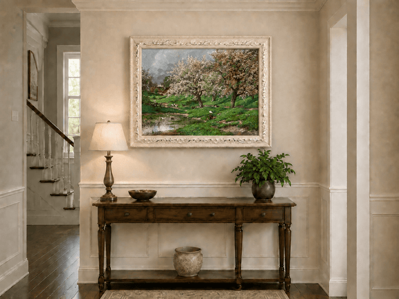 Framed hand-painted blossom orchard oil painting beside a quiet spring pond displayed above an entryway console table.