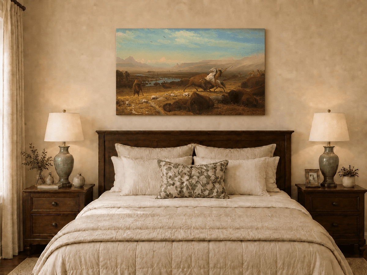 Unframed hand-painted western landscape oil painting of a buffalo hunt across open prairie displayed above a wooden bed in a neutral bedroom.
