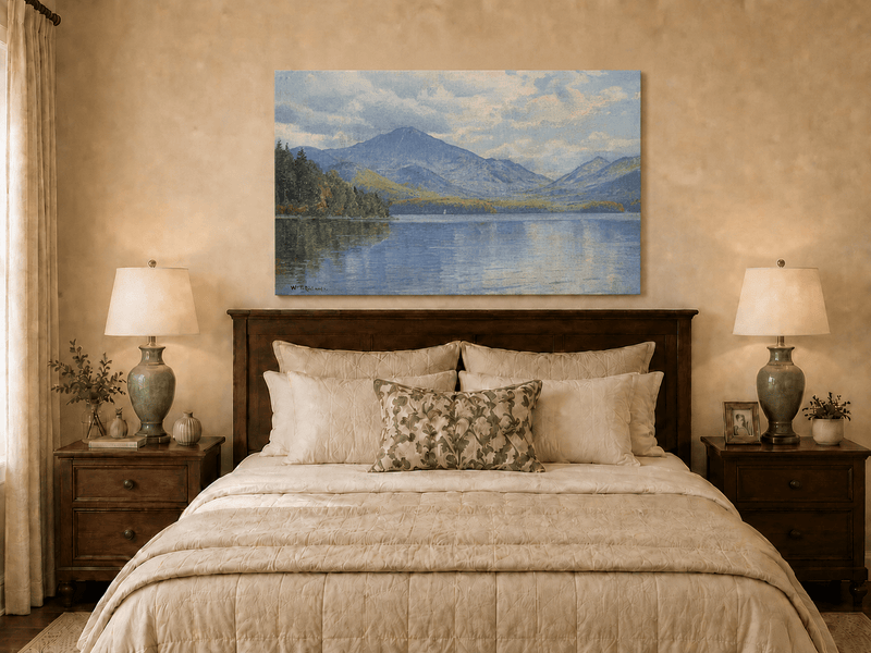 Unframed hand-painted lake oil painting with calm reflections and a forested shoreline displayed above a wooden bed in a neutral bedroom.