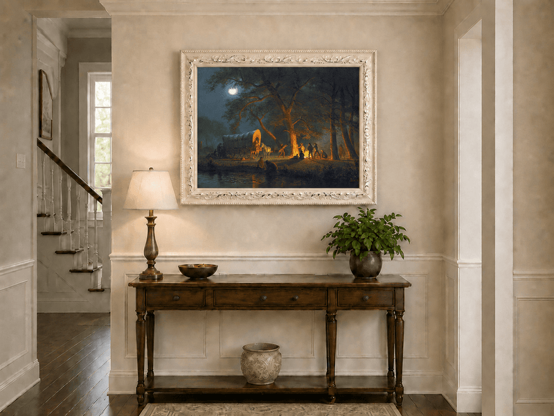 Framed hand-painted moonlit forest oil painting with figures gathered around a campfire displayed above an entryway console table.