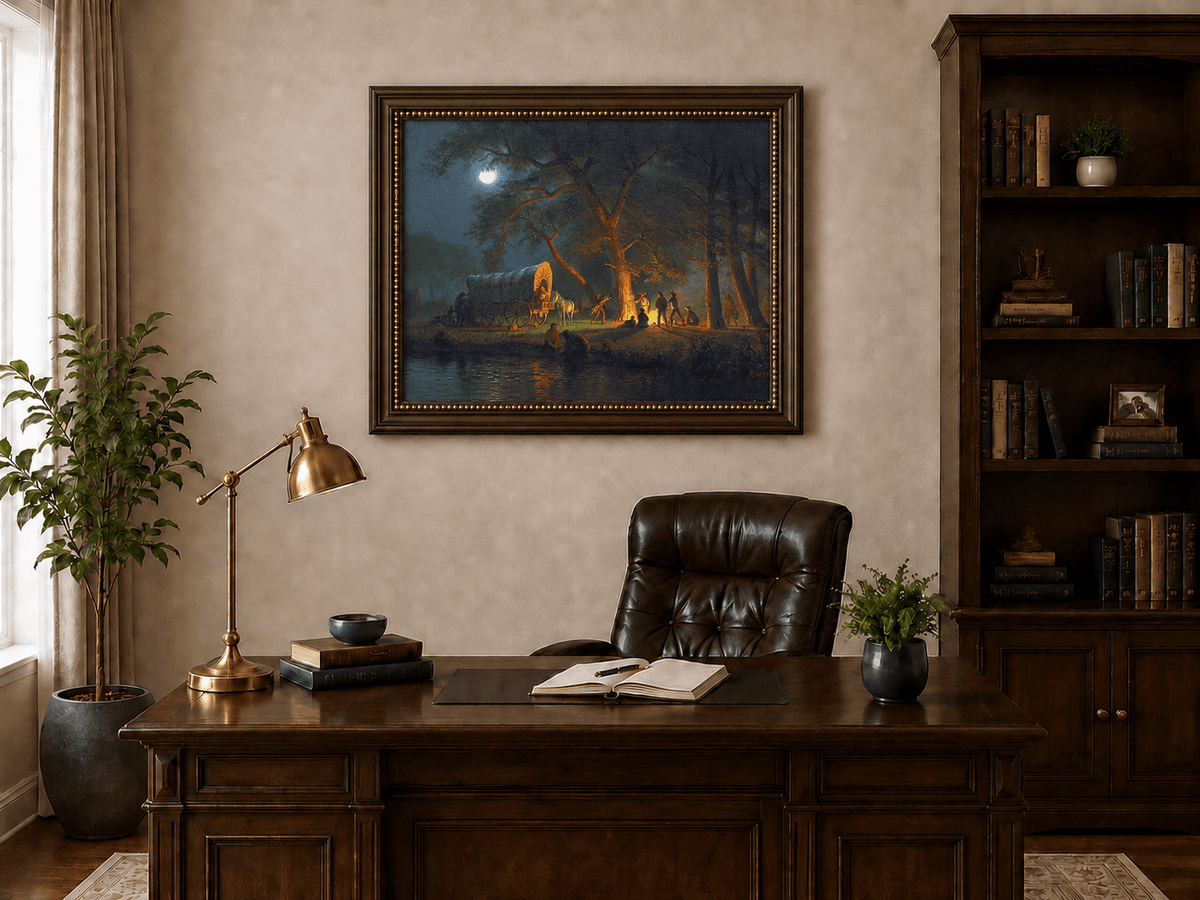 Framed hand-painted moonlit forest oil painting with figures gathered around a campfire displayed above a traditional home office desk.