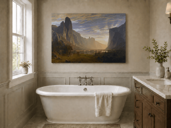 Unframed hand-painted cliffs and river oil painting illuminated by warm golden light displayed above a freestanding bathtub.