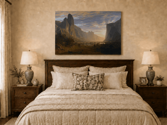 Unframed hand-painted cliffs and river oil painting illuminated by warm golden light displayed above a wooden bed in a neutral bedroom.