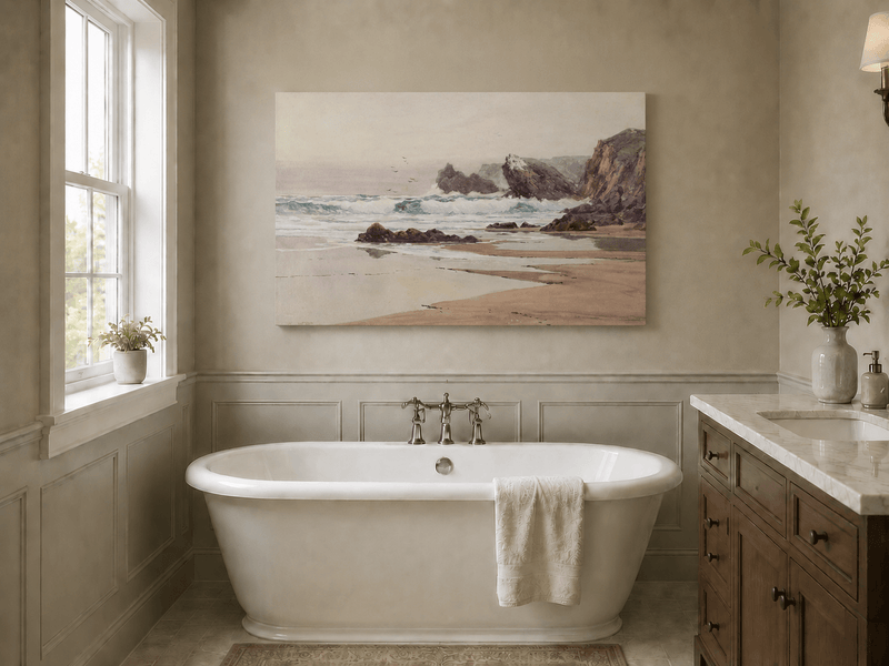 Unframed hand-painted coastal beach oil painting with crashing waves and cliffside rocks displayed above a freestanding bathtub.