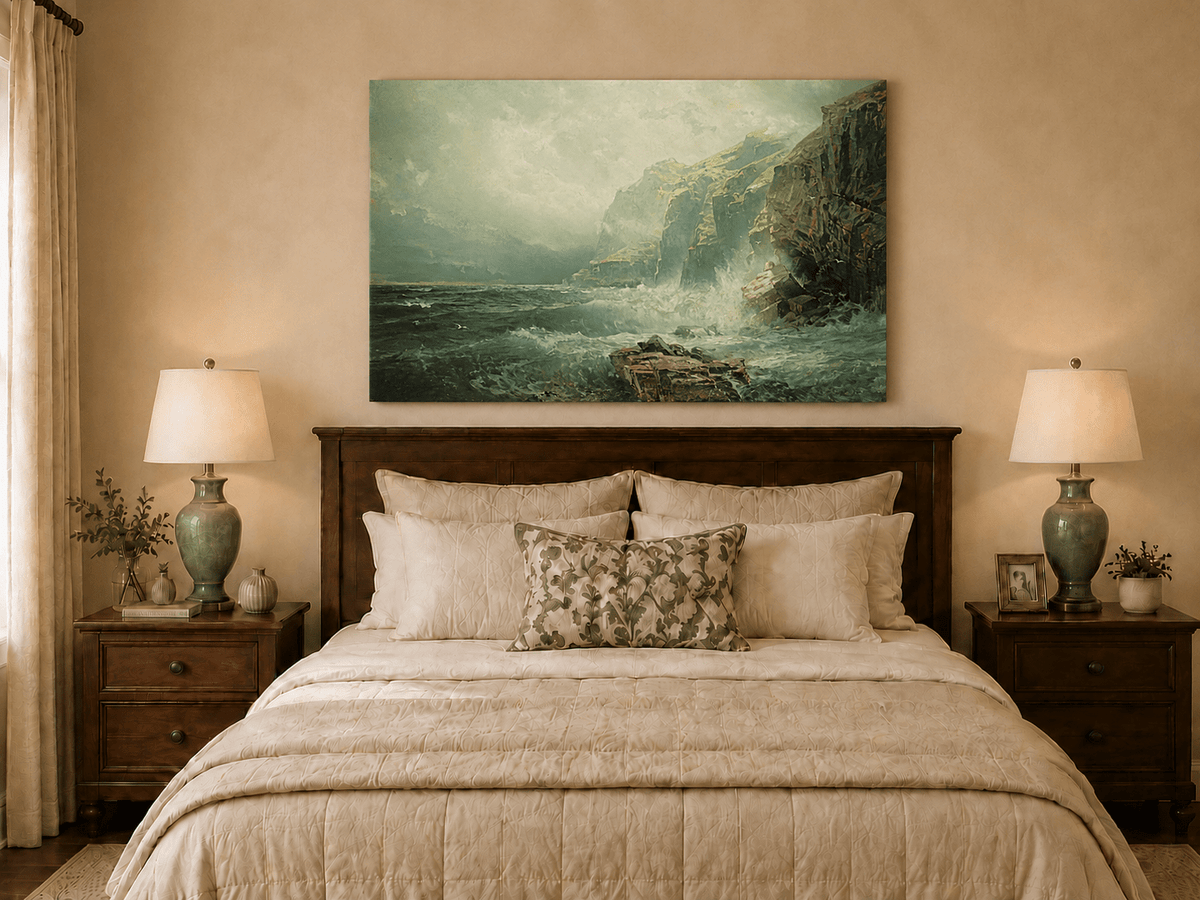 Unframed hand-painted coastal cliff oil painting with crashing waves beneath a misty sky displayed above a wooden bed in a neutral bedroom.