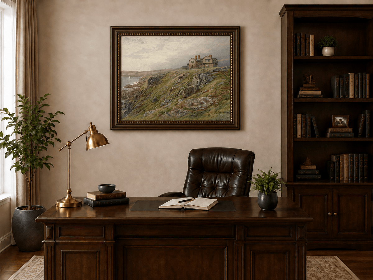 Framed hand-painted coastal oil painting with a cliff house, rocky slopes and seaside view displayed above a traditional home office desk.