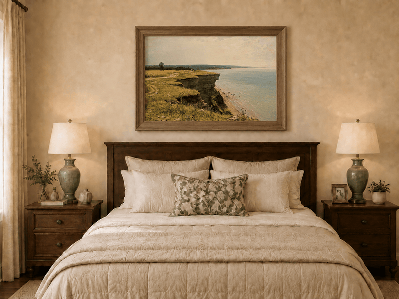 Framed hand-painted coastal landscape oil painting with a grassy cliff and expansive sea view displayed above a wooden bed in a neutral bedroom.