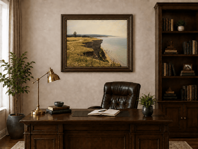 Framed hand-painted coastal landscape oil painting with a grassy cliff and expansive sea view displayed above a traditional home office desk.