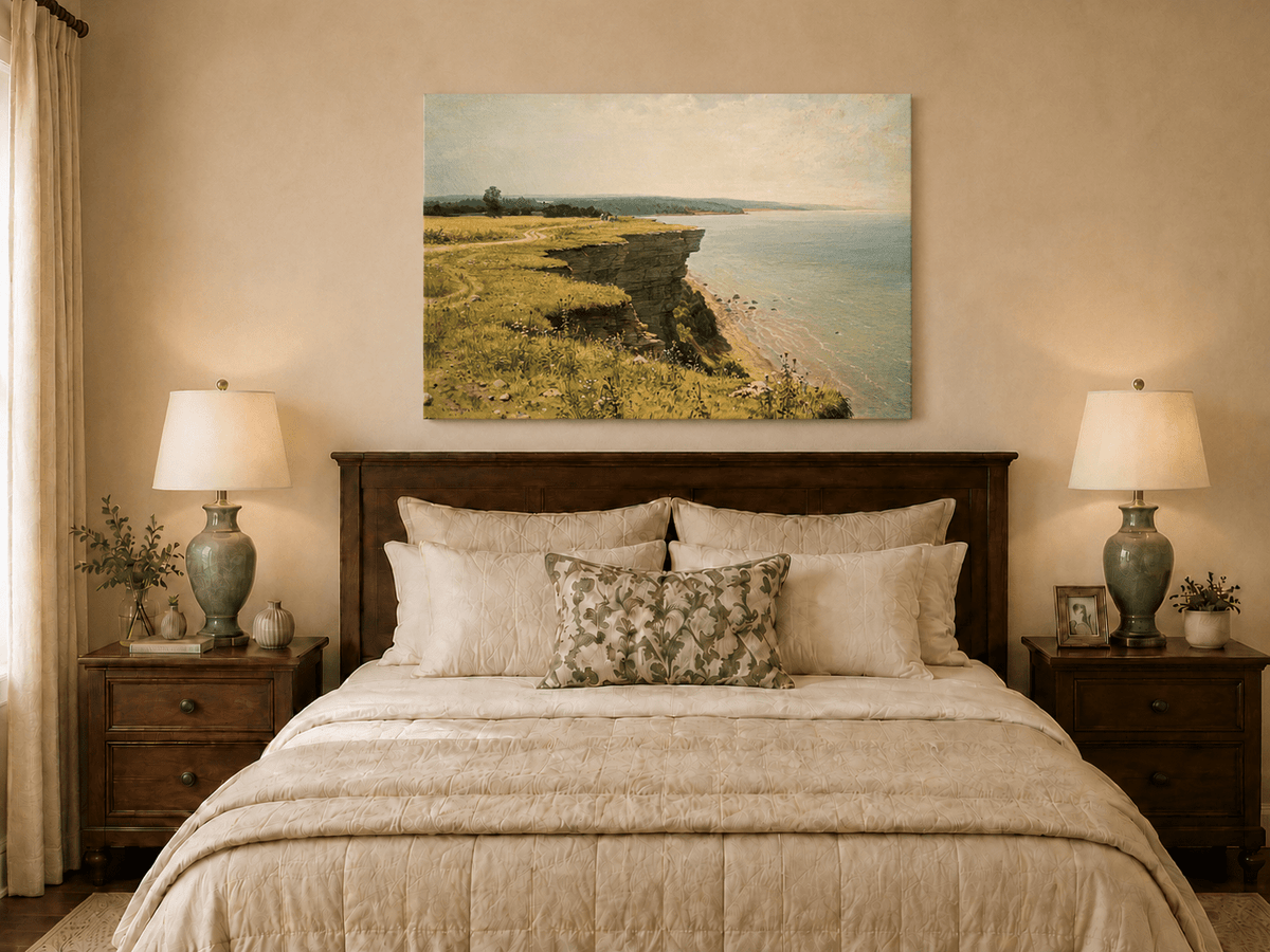 Unframed hand-painted coastal landscape oil painting with a grassy cliff and expansive sea view displayed above a wooden bed in a neutral bedroom.
