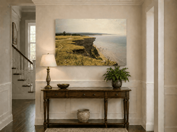 Unframed hand-painted coastal landscape oil painting with a grassy cliff and expansive sea view displayed above an entryway console table.