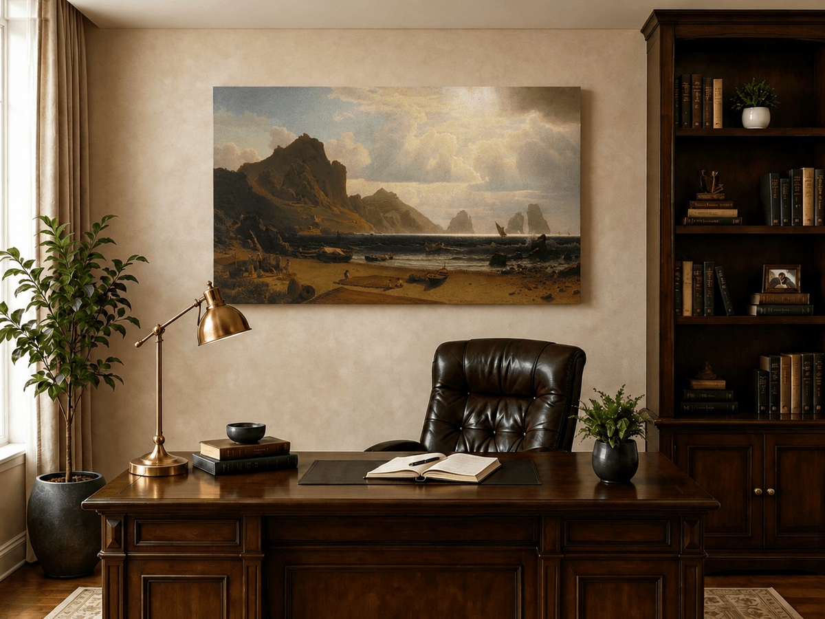 Unframed hand-painted coastal cliffs oil painting with fishing boats and figures on a rocky beach displayed above a traditional home office desk.