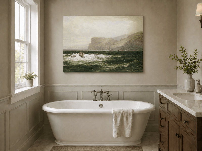 Unframed hand-painted seascape oil painting with coastal cliffs, crashing waves and a seaside rock displayed above a freestanding bathtub.