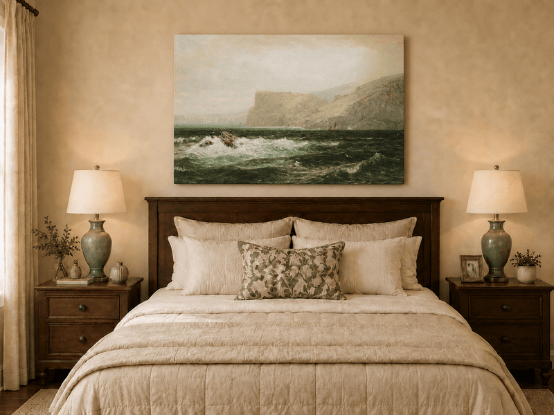 Unframed hand-painted seascape oil painting with coastal cliffs, crashing waves and a seaside rock displayed above a wooden bed in a neutral bedroom.