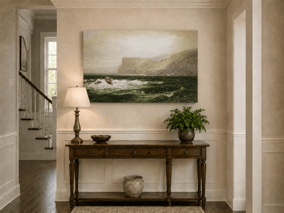 Unframed hand-painted seascape oil painting with coastal cliffs, crashing waves and a seaside rock displayed above an entryway console table.