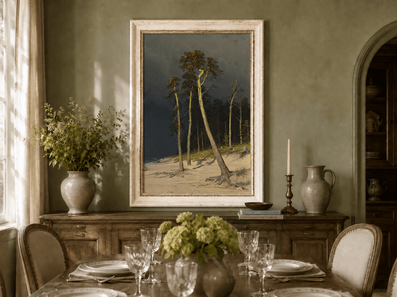 Framed hand-painted coastal forest oil painting with tall pines on a sandy shore displayed above a formal dining table.