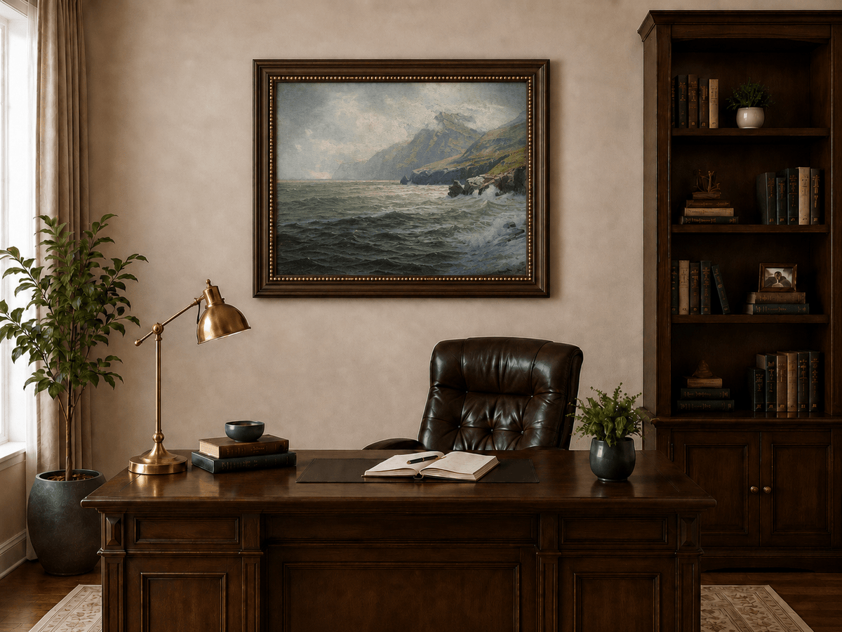 Framed hand-painted coastal mountain oil painting with waves breaking on a rocky shore displayed above a traditional home office desk.